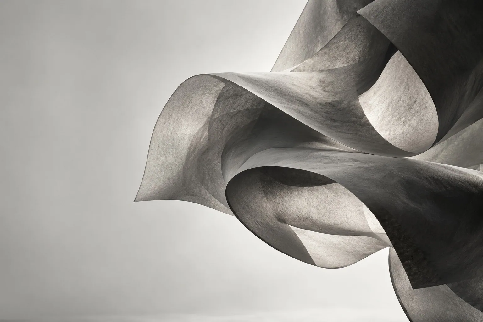 An abstract study of sculptural folds in charcoal and stone